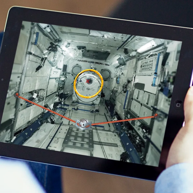 Person using an ipad and interacting with live from space software